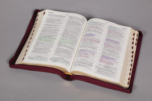a bible with its pages open and highlighted text