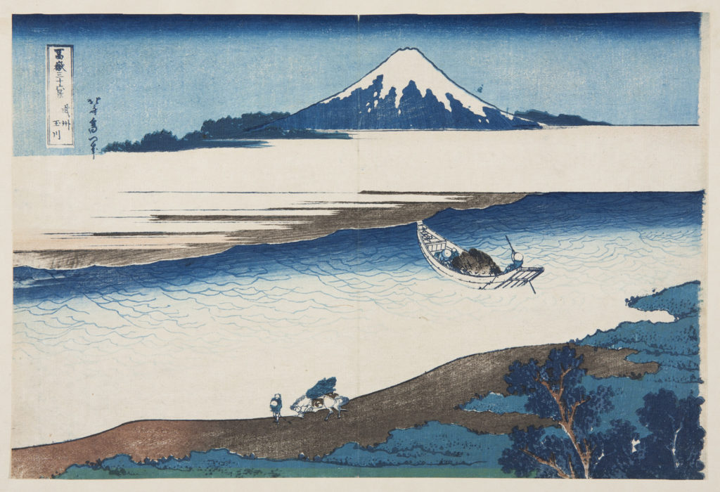 Japanese print of a landscape. A boat sails on the river. In the foreground a figure walks along the bank with a horse. Mount Fuji rises up in the background.