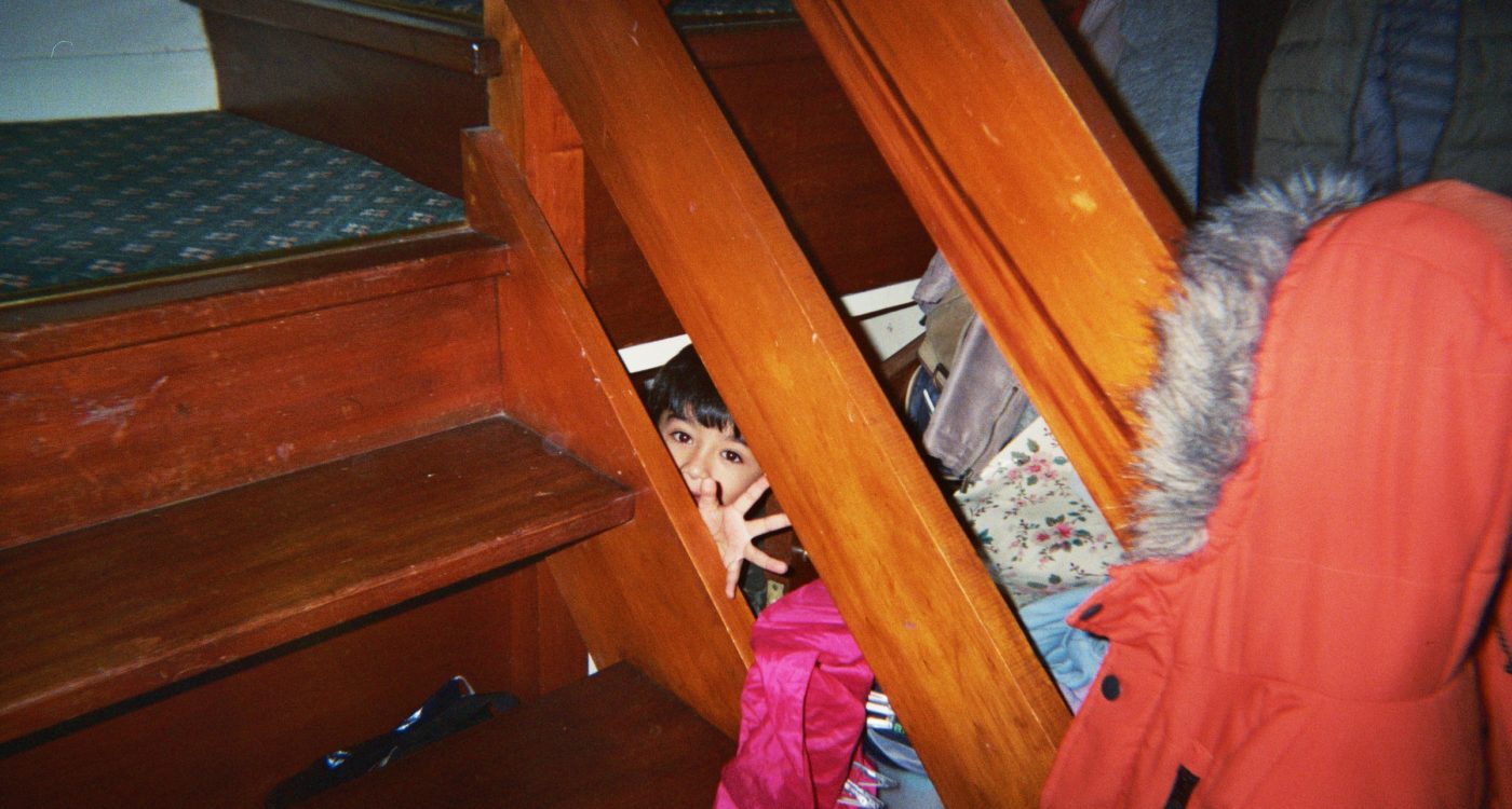 Beatriz's photograph (for the 21st Century Kids) of her younger brother. He is taking a peak between the banisters behind the stairs.