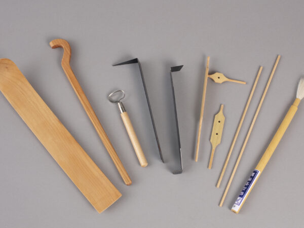 row of tools used for forming, trimming, measuring and painting ceramics