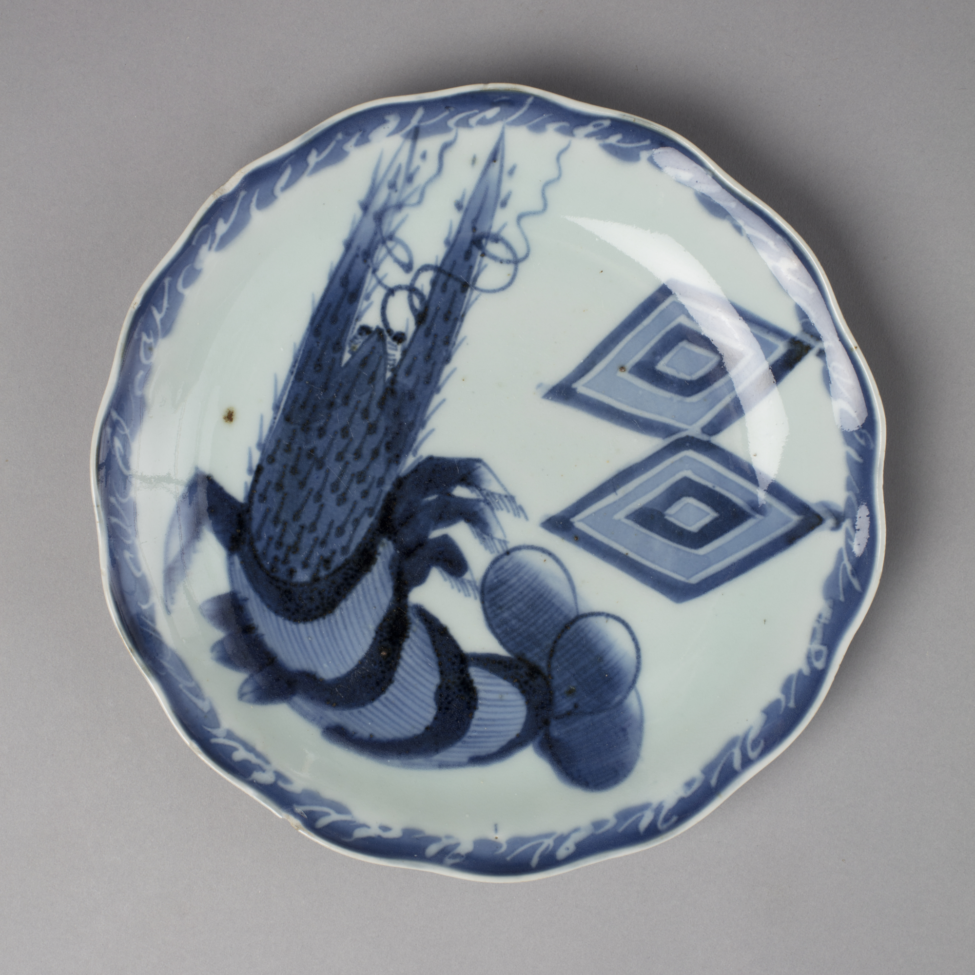 Dish with design of lobster and rice measure crests in blue on white