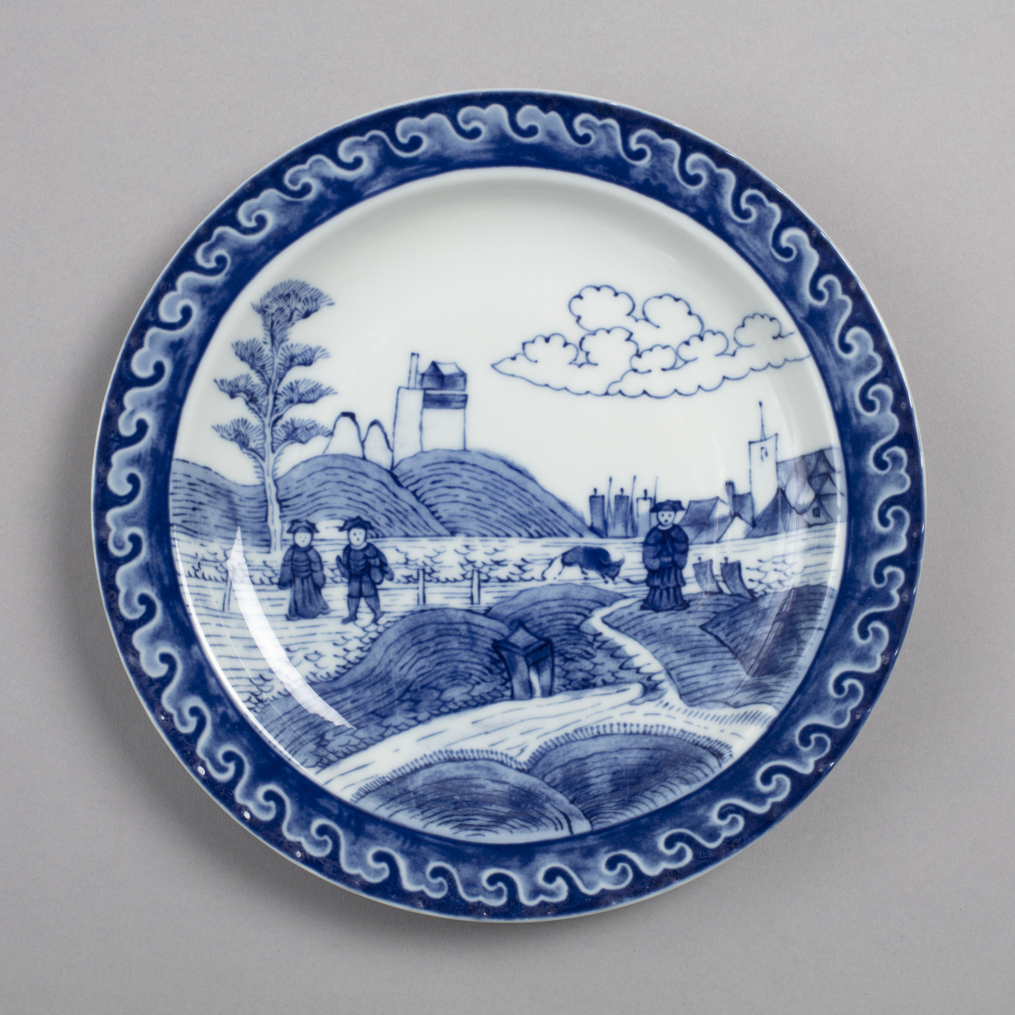 Dish with design of figures in landscape in blue decoration