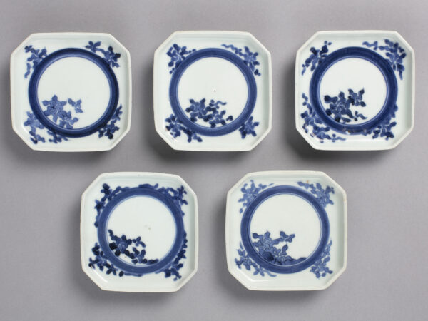 Set of five small square dishes with blue on white floral circle designs