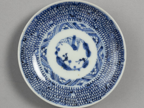 Small dish with blue on white design of plum, pine, and bamboo