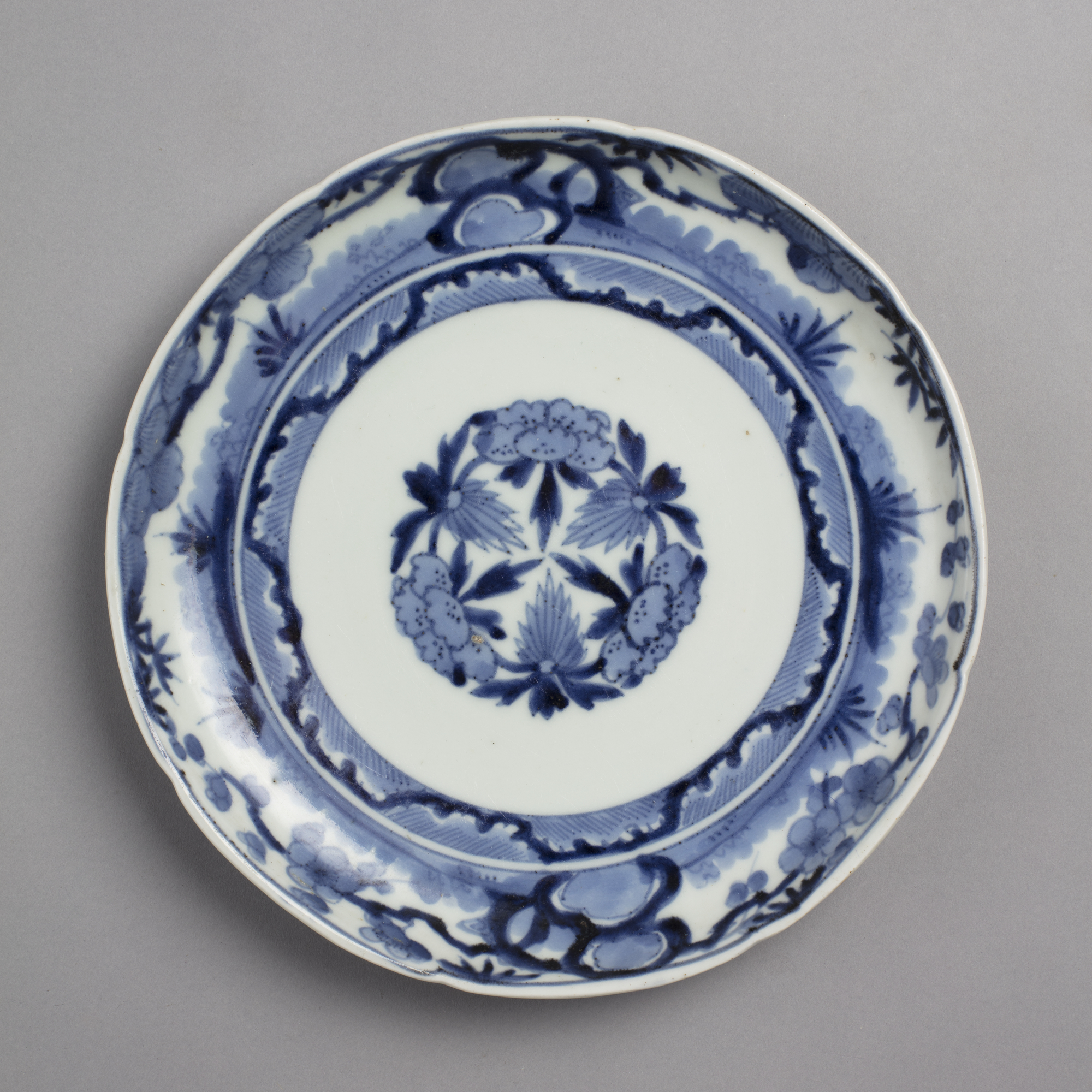 Dish with blue on white design of pine, bamboo, and plum