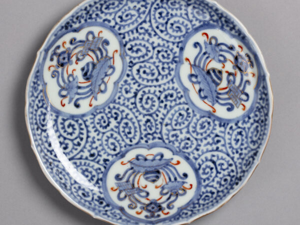 Dish with octopus scroll pattern in blue and orange on white