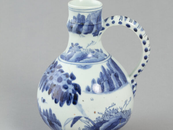 Wine jug with design of figures in landscape in blue decoration