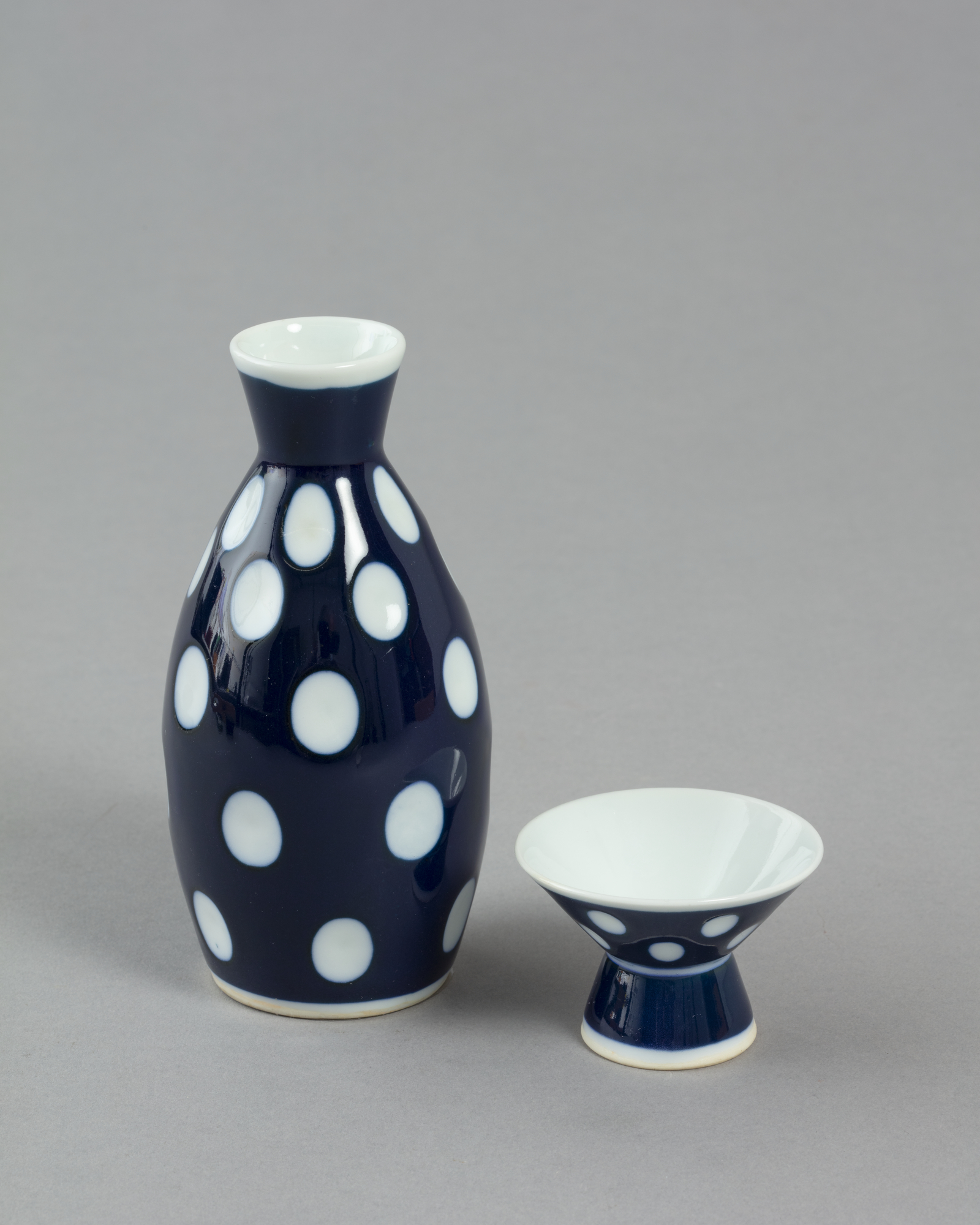 Sake flask and cup with dark blue design with white spots