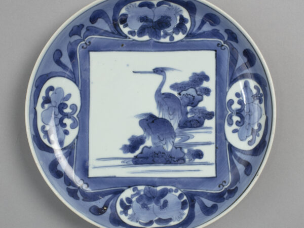 Dish with blue on white design of herons and pomegranates