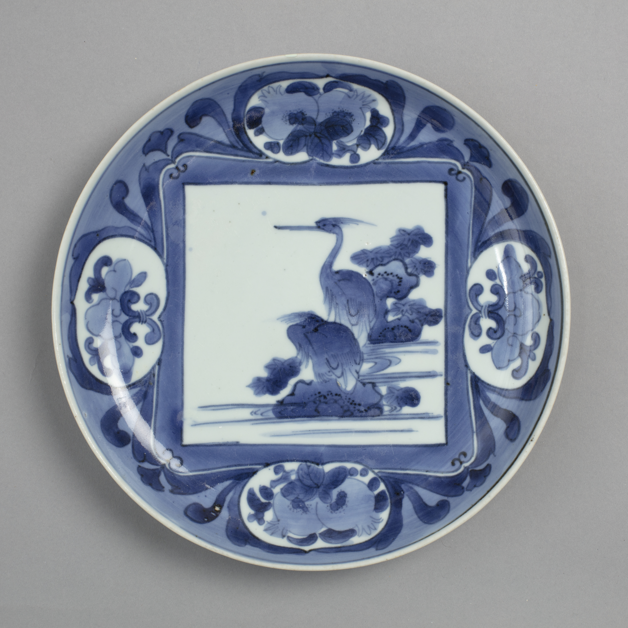 Dish with blue on white design of herons and pomegranates