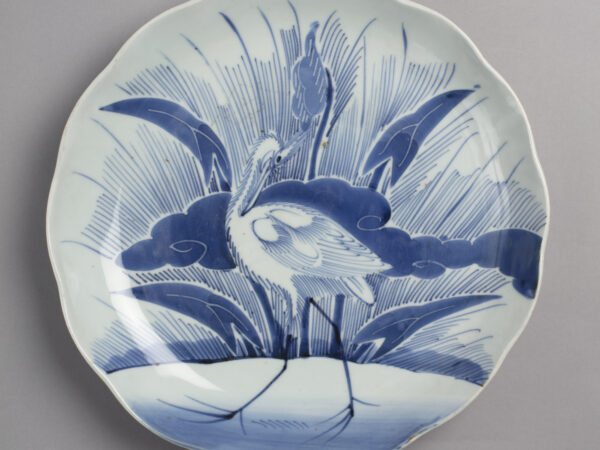 Large dish with blue on white design of heron and arrowhead plant