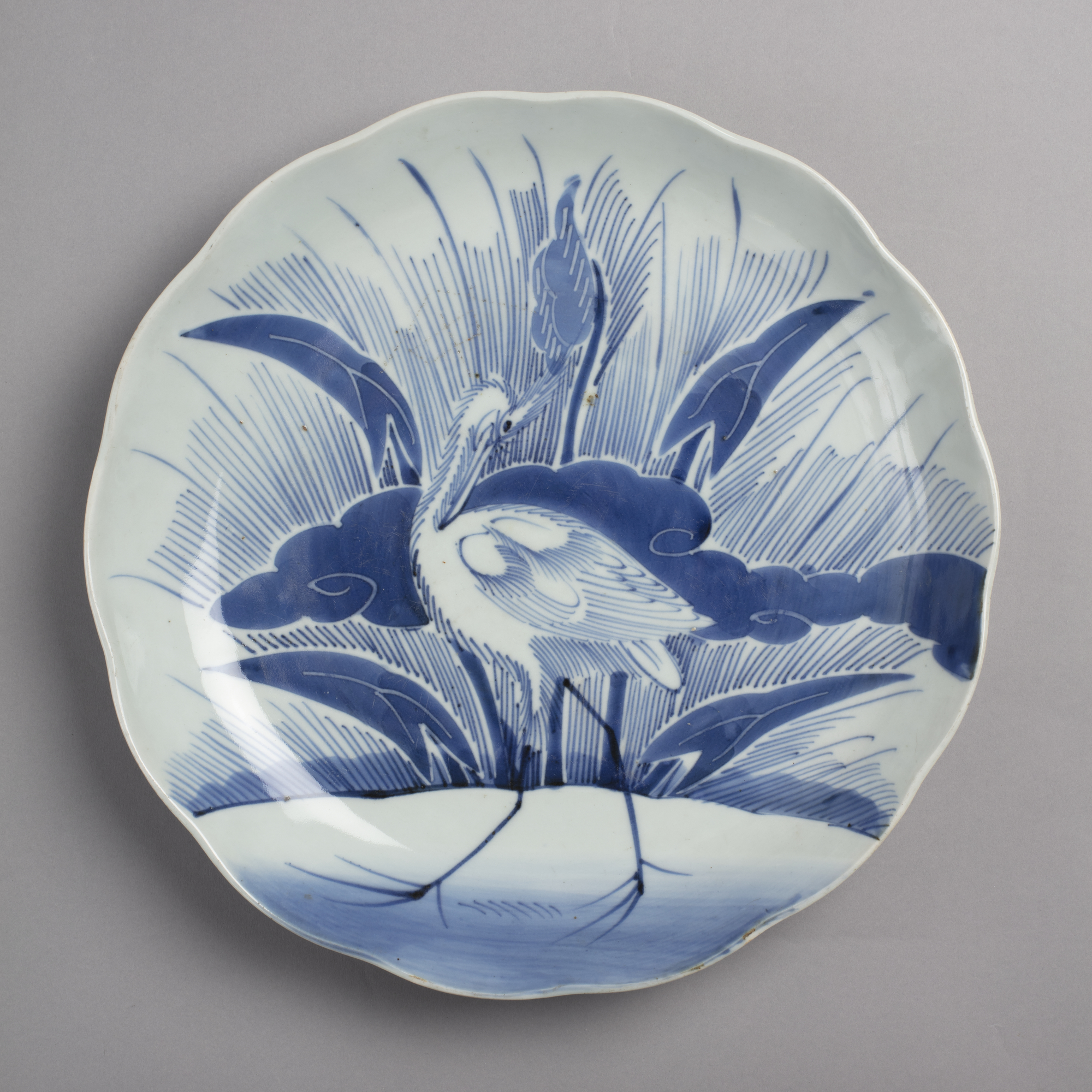 Large dish with blue on white design of heron and arrowhead plant