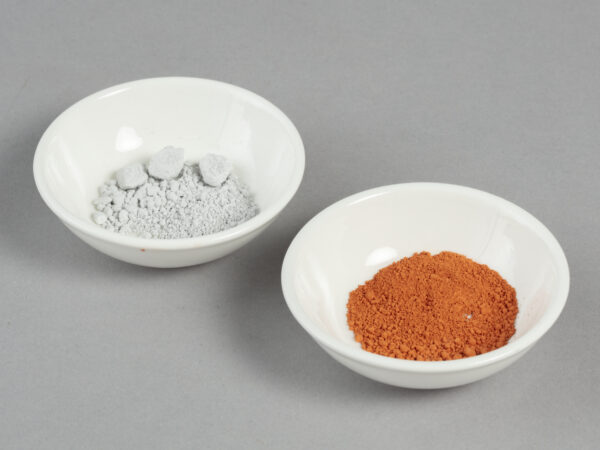 two bowls with powdered samples used to make green and red colours