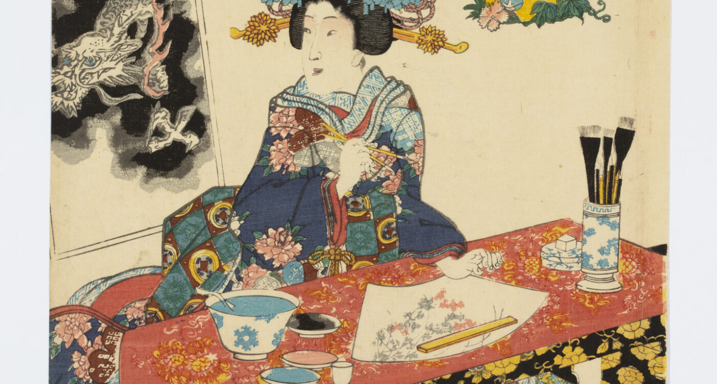 woman in a woodblock print uses small porcelain dishes to hold the ink for a fan painting and a larger porcelain bowl to wash her brushes. A ceramic brush pot and water dropper sits on her desk