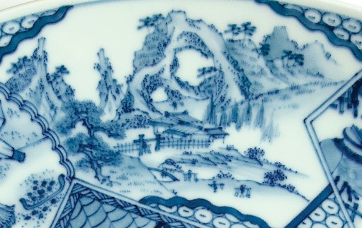detail of a design on a dish showing people mining porcelain stone