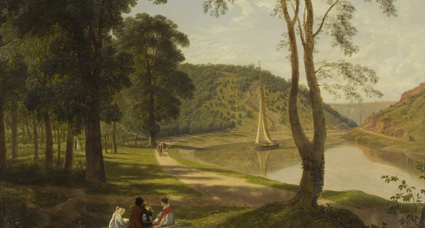 A group of people sat by a river