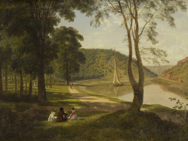 A group of people sat by a river