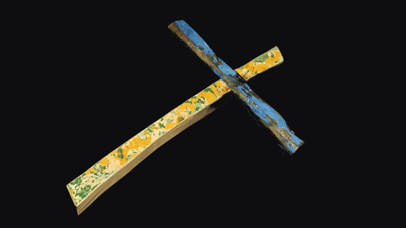 The Lampedusa Cross - a wooden cross covered with flecks of blue, green and yellow paint.