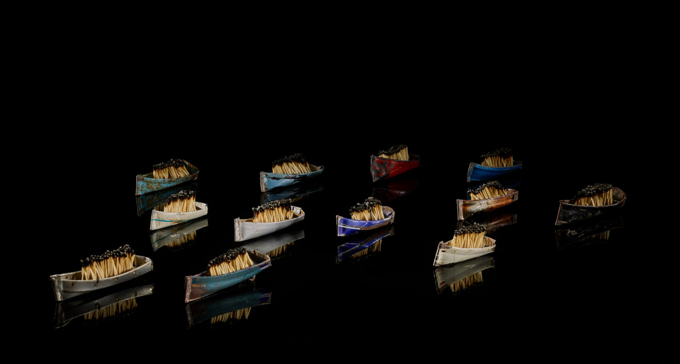 12 small model boats made of tyres and matchsticks