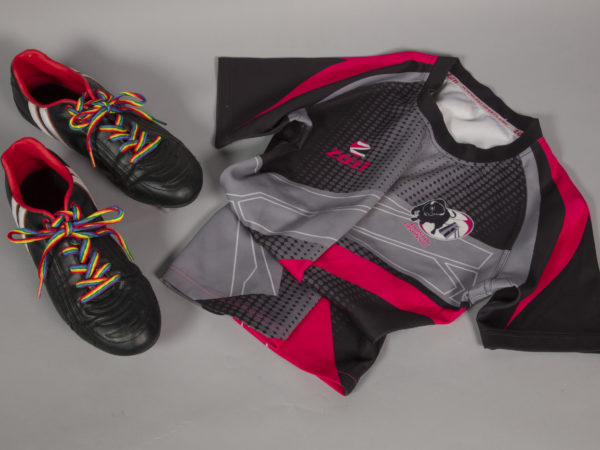 black, red and grey rugby shirt and boots