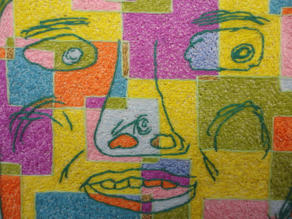a colourful stitched face