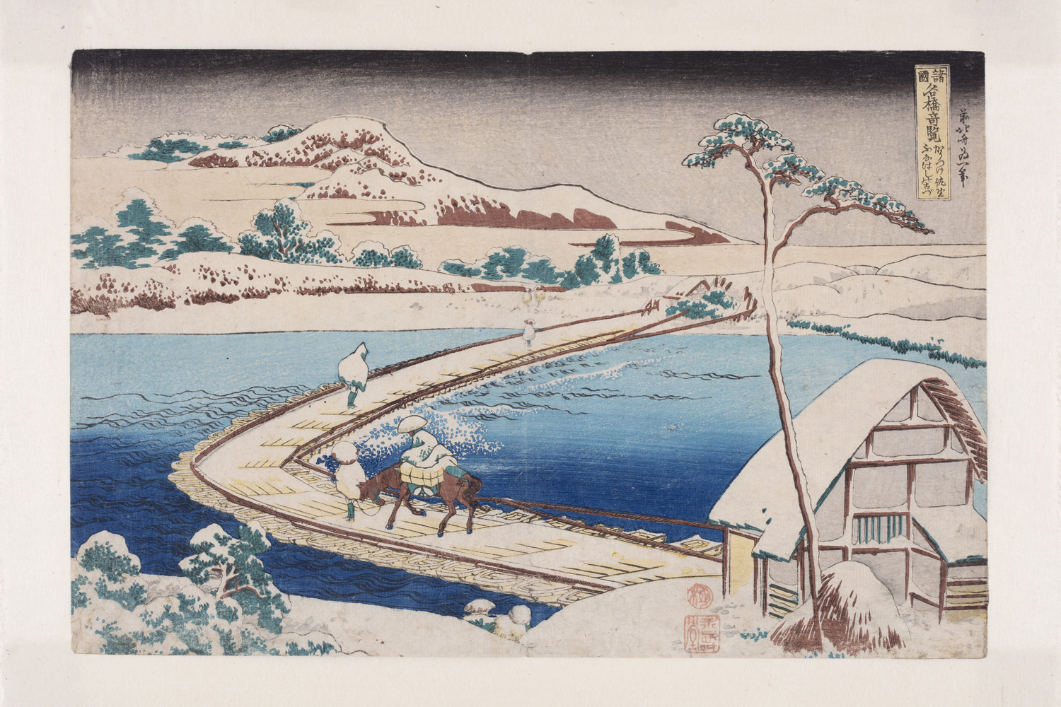 Japanese print of a landscape. a pontoon bridge crosses the marshes. Travellers cross the bridge, one riding a horse, others walking. In the foreground is a building and in the background a mountain rises up.