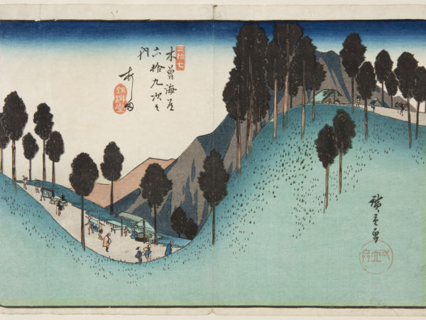 Japanese print. Raod weaves through the wooded mountains. Small figures walk along, porters carry heavy bundles, others walk with sticks. Sheltered resting places can be seen.