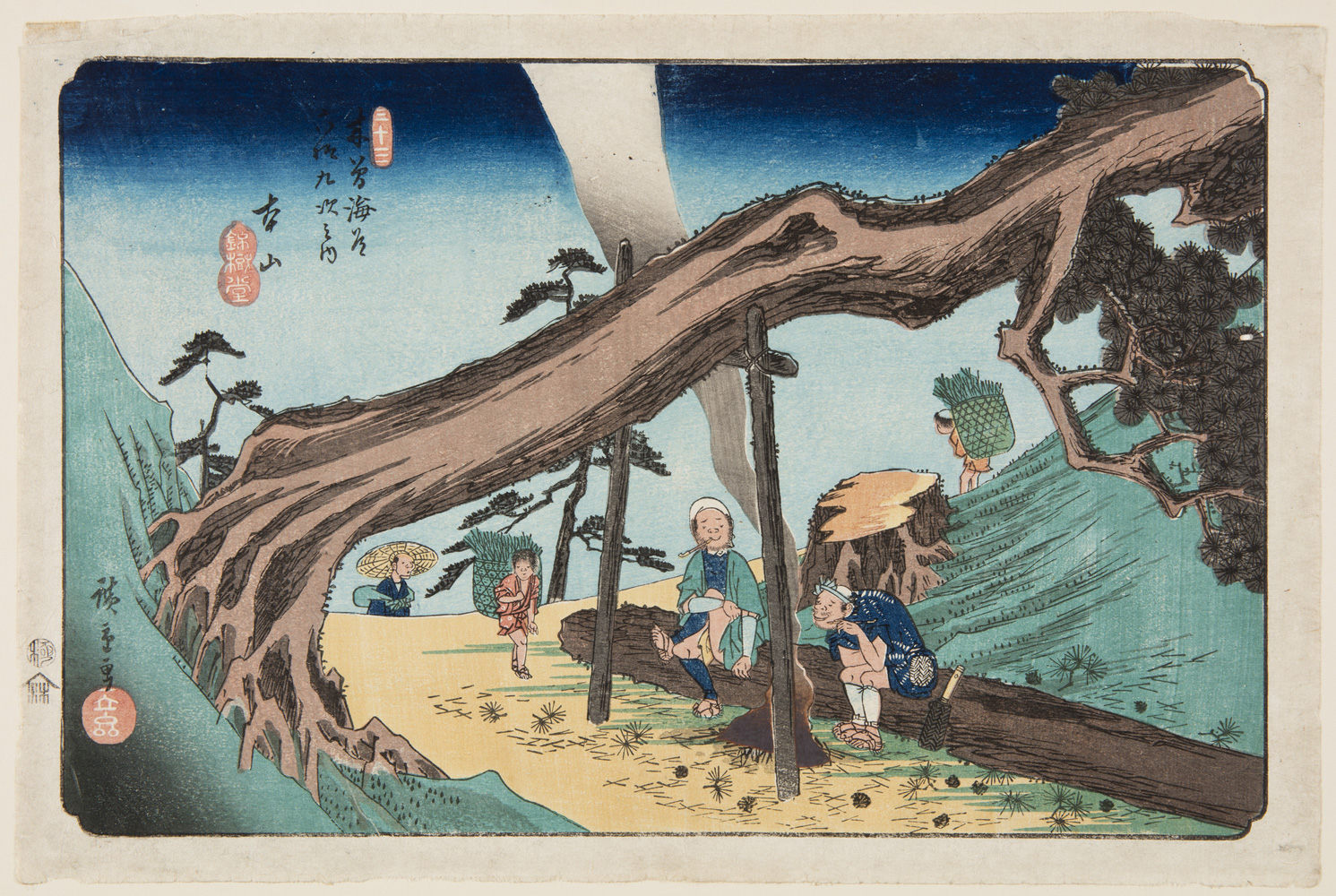 Japanese print of a mountain road. A fallen tree is held up with posts and underneath two men have made a campfire and sit on a fallen log. Three other figures walk along the road carrying large baskets on their back.