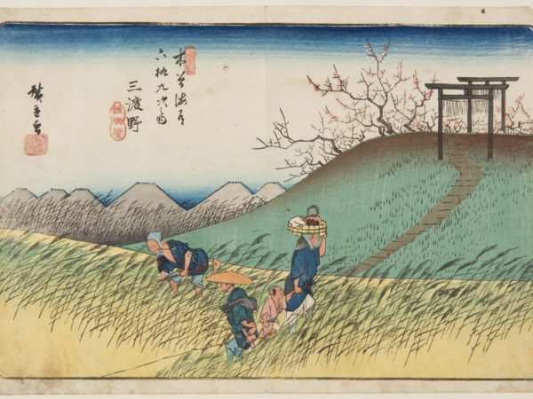 Japanese print of a rural landscape. Four figures dressed in traditional clothes, one bent over tending the fields, another standing, a woman carries a basket on her head and holds a child's hand. A path weaves away over a hill, there is blossom in the trees.