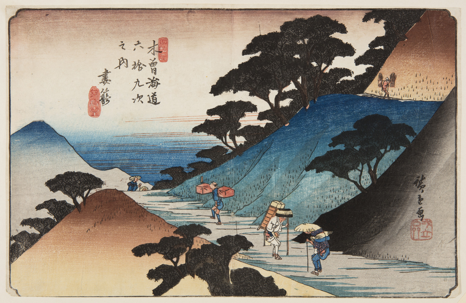 Japanese print of a landscape. A road through mountains. Four travelers walk along the road in traditional dress carrying boxes and holding walking sticks.