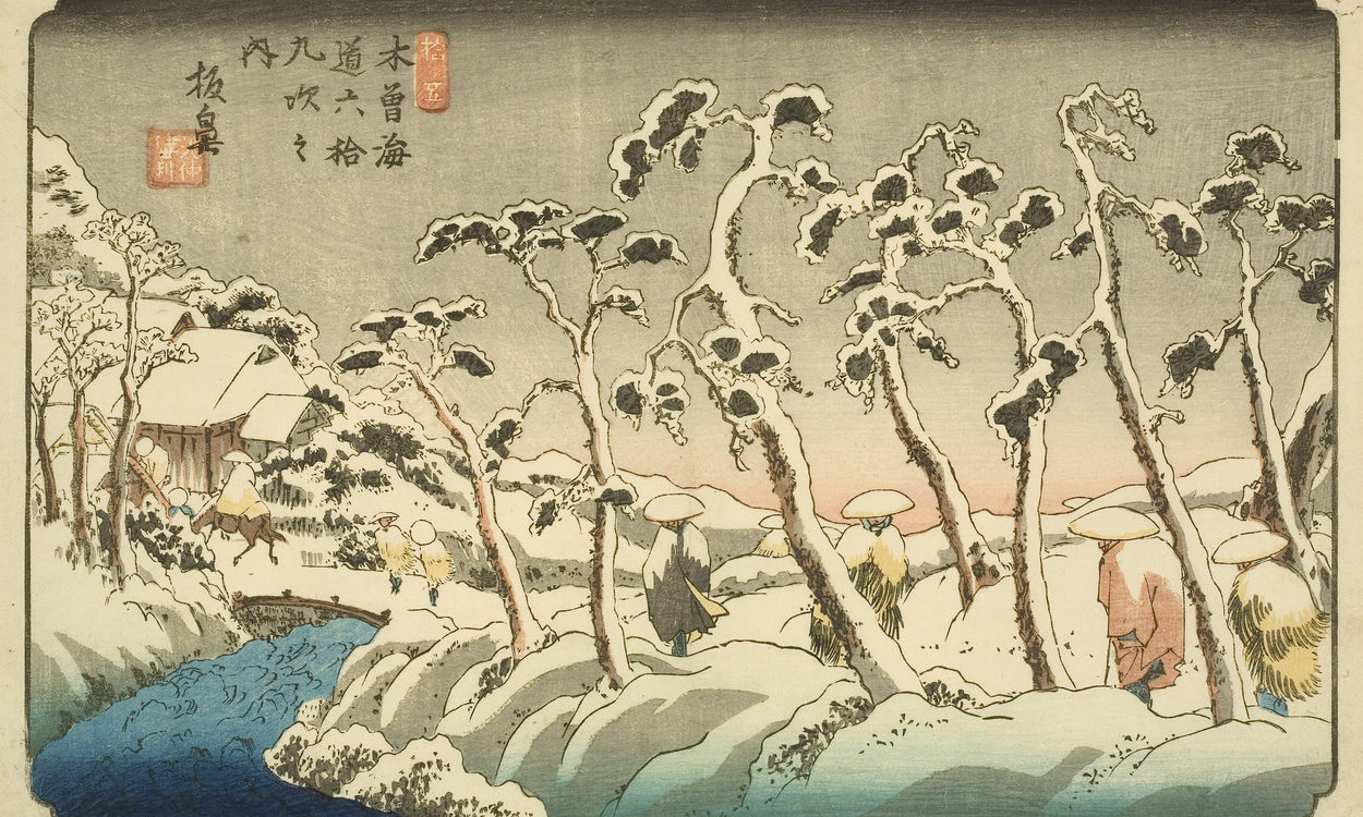 Japanese print of a winter scene. Snow covers the trees. Figures, dressed in traditional clothes and hats, walk along the path. The path crosses the river over a bridge and leads to a building.