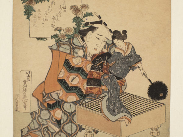 Japanese print of a man, in traditional robes, kneeling at a table, He is holding a puppet of a woman dressed in a kimono.