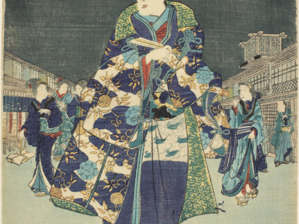A Japanese print of a street scene at night, a full moon is in the sky. In the foreground there is a man dressed in colourful traditional clothes, other figures in similar clothes walk behind him, the buildings either side of the street recede.