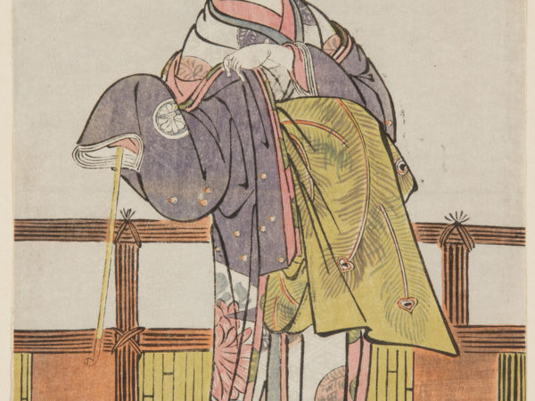 A Japanese print of an actor standing with one hand holding the sleeve of the long flowing traditional robes.