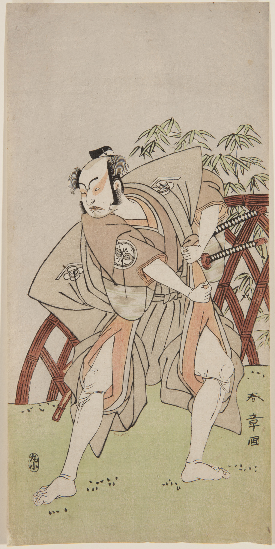 A Japanese print of an actor stood in a dramatic pose in samurai costume.