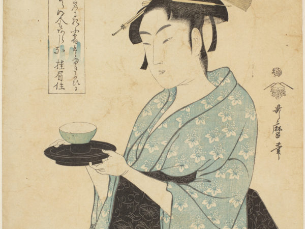 Japanese print with of a woman wearing traditional clothes, light blue with white flowers and black sash. She is holding a small bowl on a small tray. Japanese text either side of the figure.