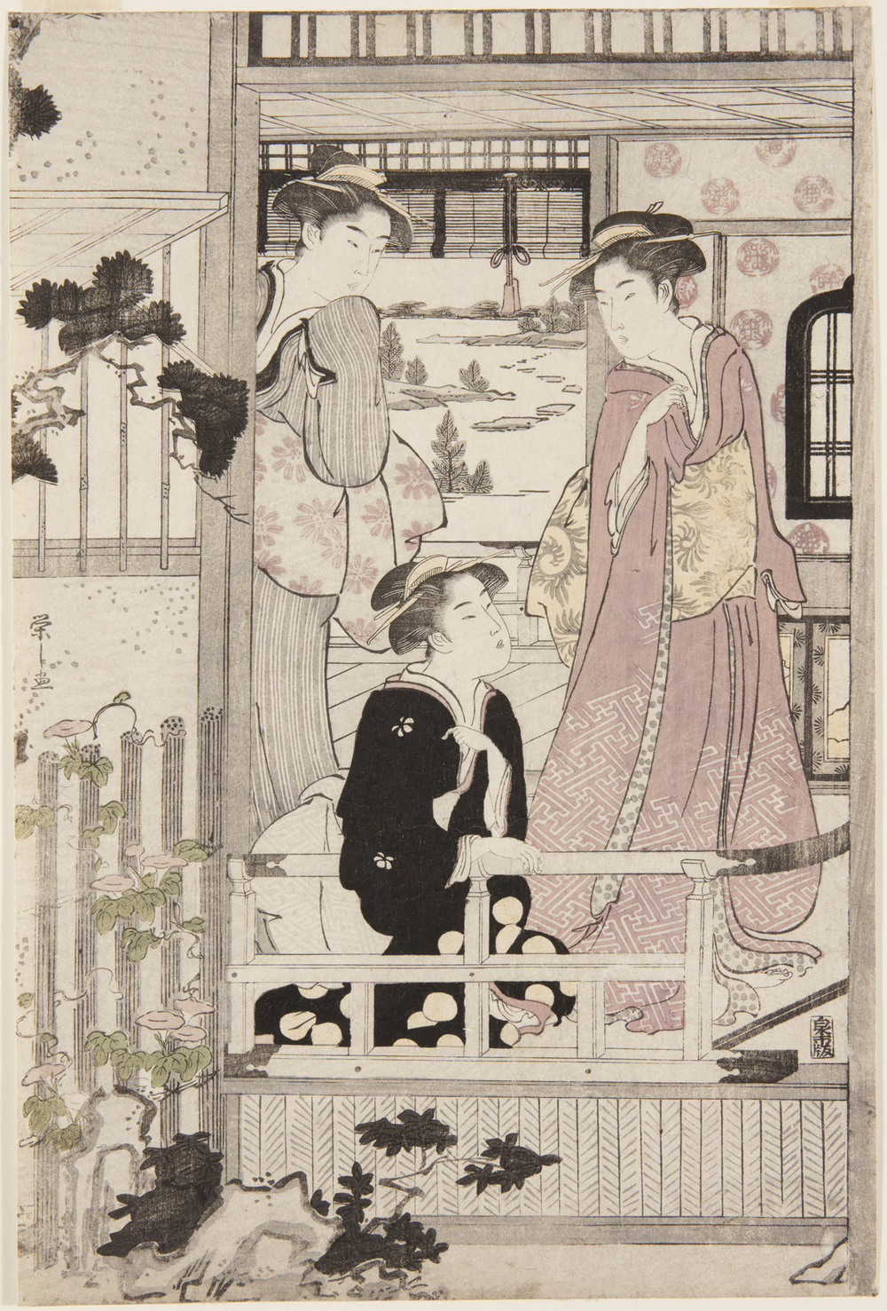 Japanese print of three women, dressed in traditional clothes, standing and kneeling on a veranda which looks out into a garden.
