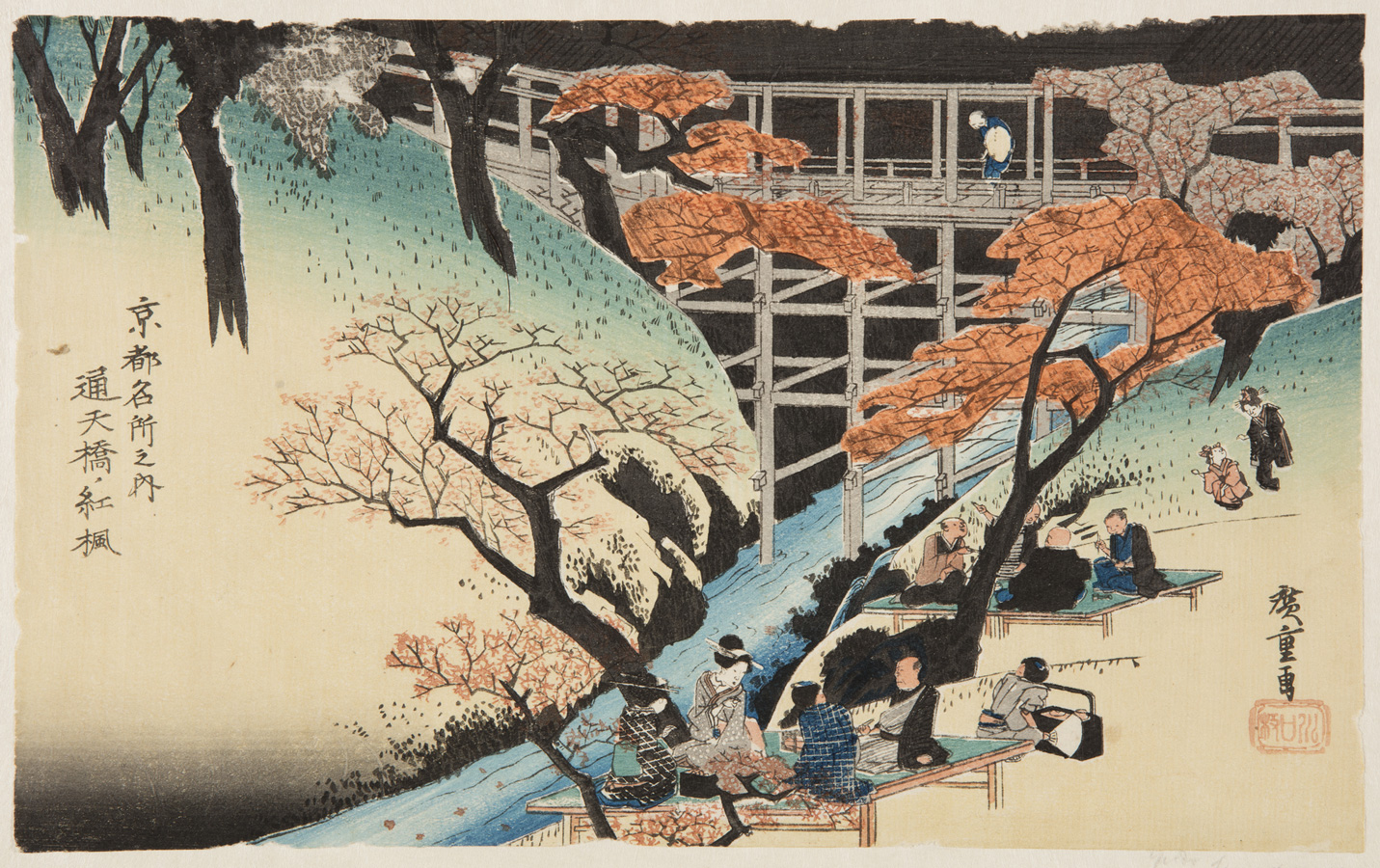 Japanese print of a landscape, people dressed in traditional clothes sit on platforms under maple trees by a river bank, behind is a wooden bridge and a figure looks down at the view.