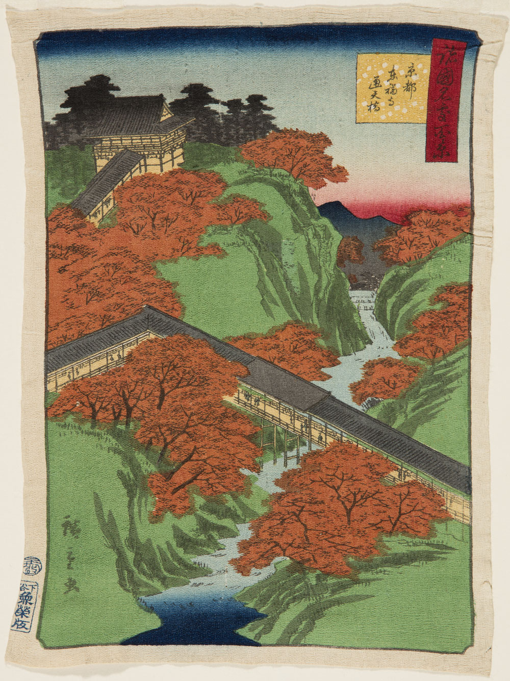 Japanese print of an aerial view of a landscape, a long covered walkway crosses a river and leads up a hill to a building.
