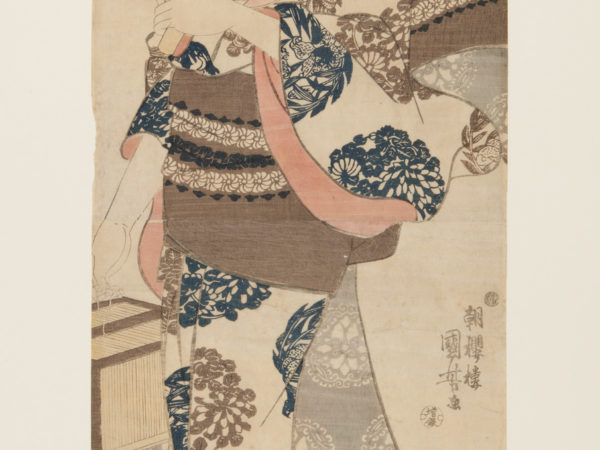 Japanese print of a woman dressed in traditional clothes, bird motifs on the fan she holds to her face and plant motifs on her kimono.