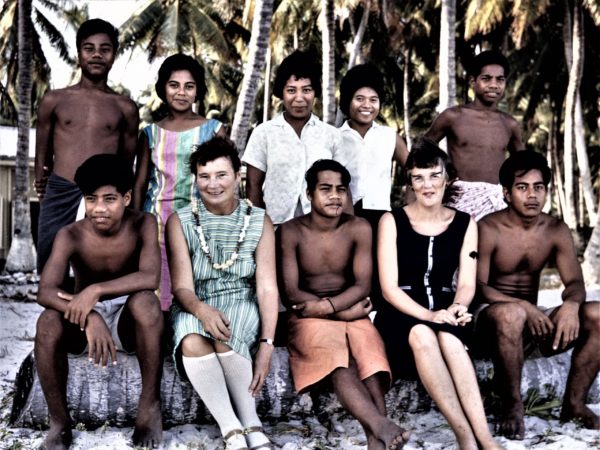 Colour photo of Pupils from King George V (boys) and Elaine Bernacchi (girls) high schools in Bikenibueu, South Tarawa, Kiribati, 1968. Peggy Mowat sits in front row, second from the left. The then headmistress of the girls' school, Nancy Lister, is seated in front row, second from the right.