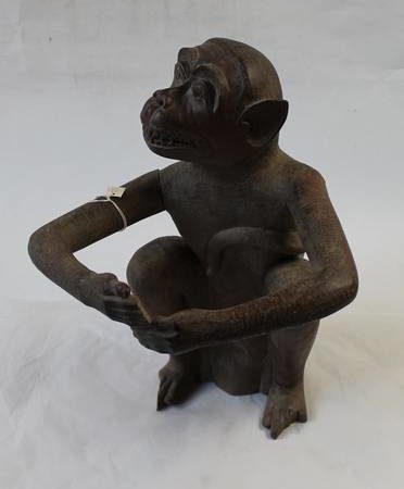 Colour photo of a wooden carving of a seated monkey made by Andaman Island prisoners for Marjory Wood's father, George Wood, c.1920s.