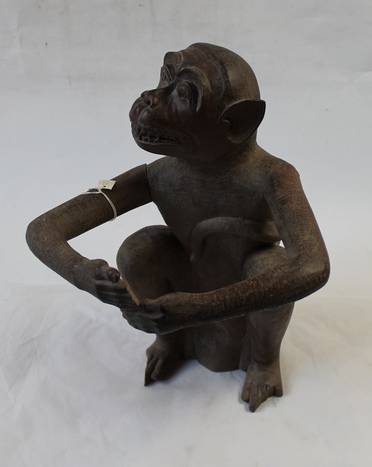 Colour photo of a wooden carving of a seated monkey made by Andaman Island prisoners for Marjory Wood's father, George Wood, c.1920s.