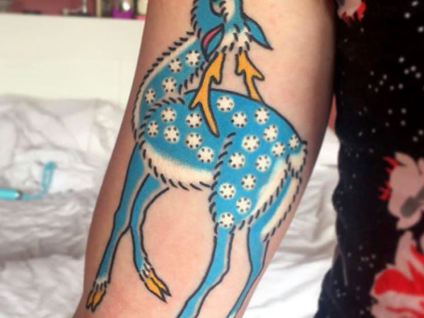 tattoo of a blue deer on an arm